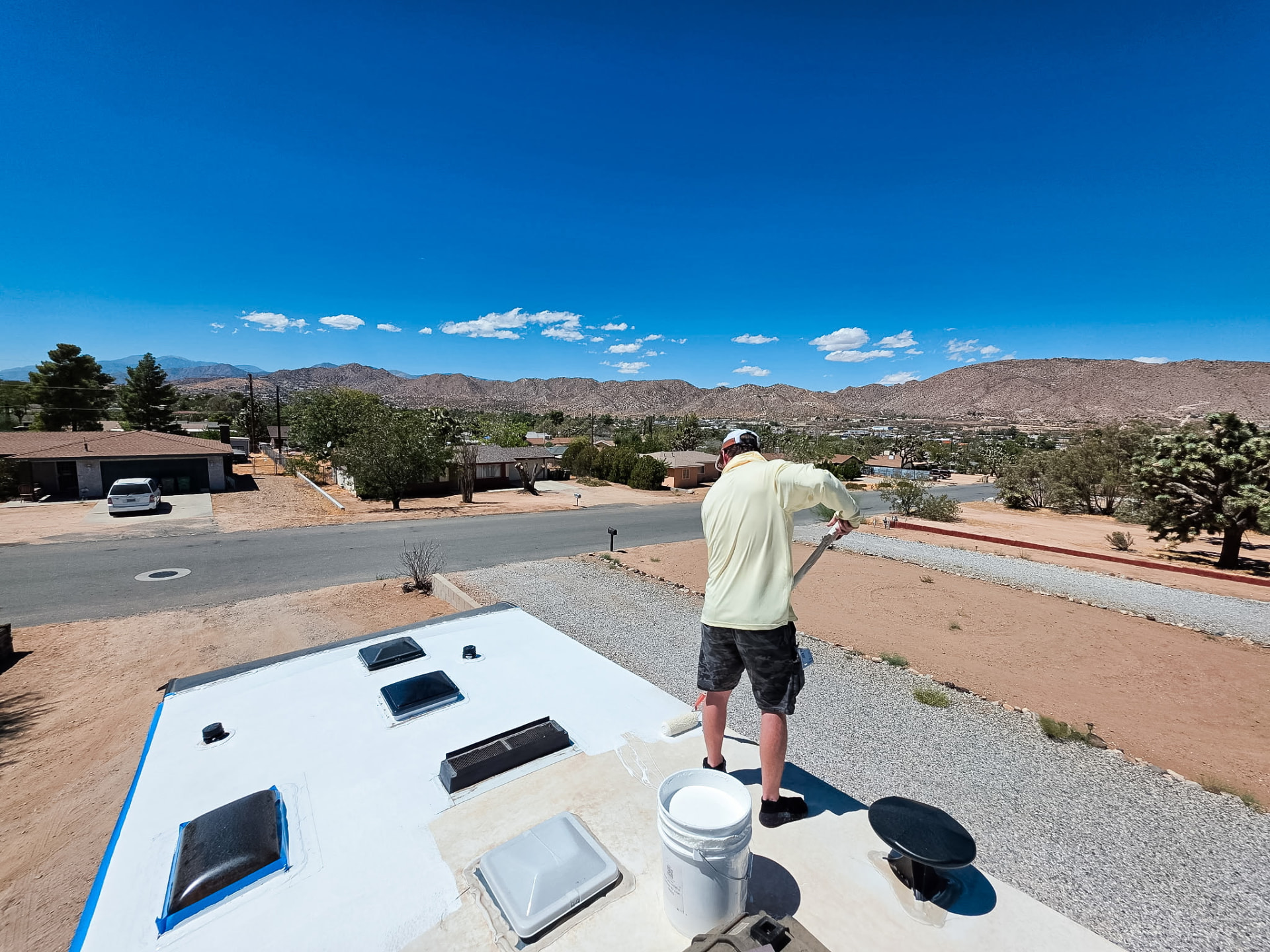 Technician coating an RV roof on site in the high desert