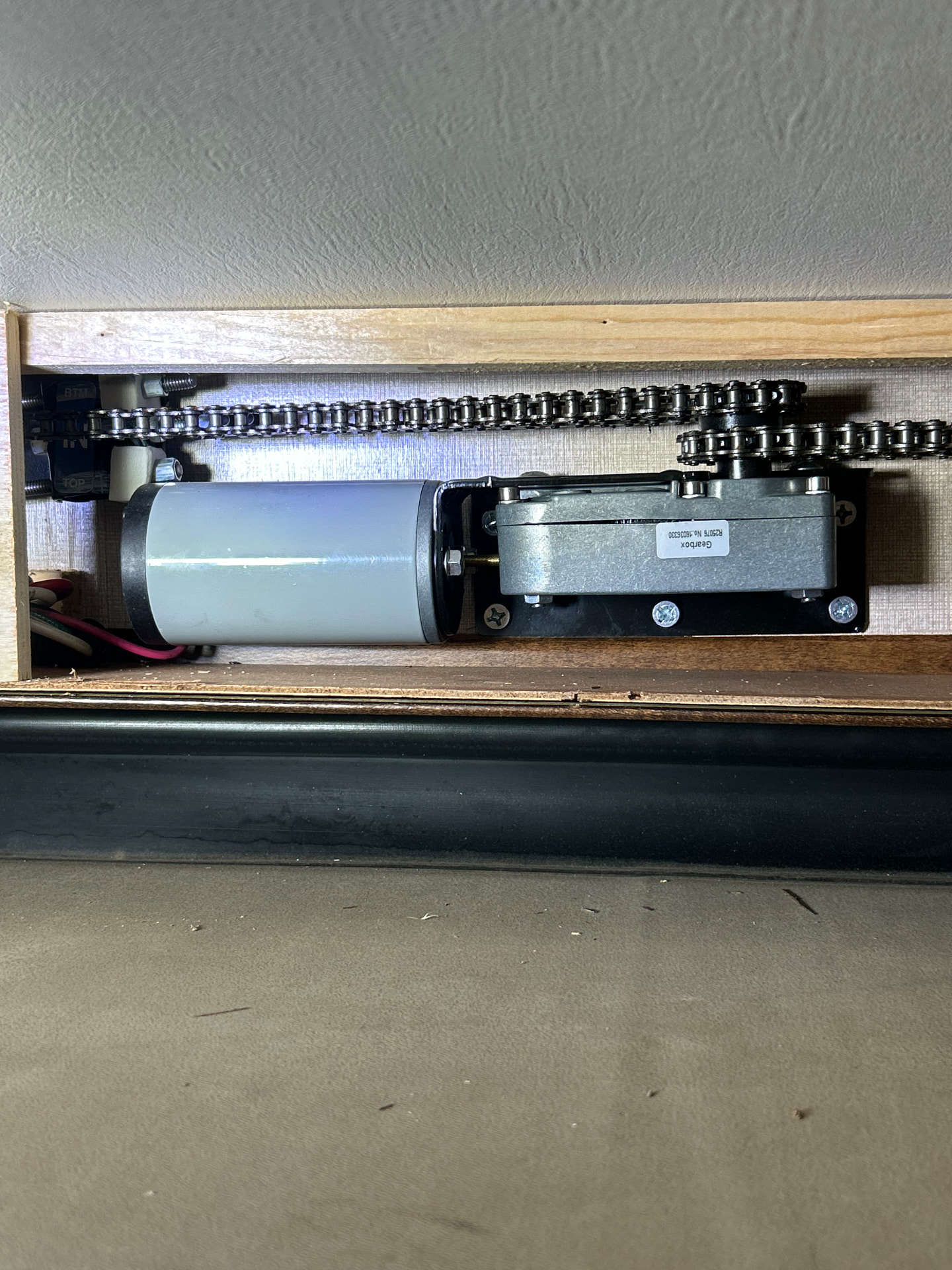 RV slide-out motor and chain assembly during inspection