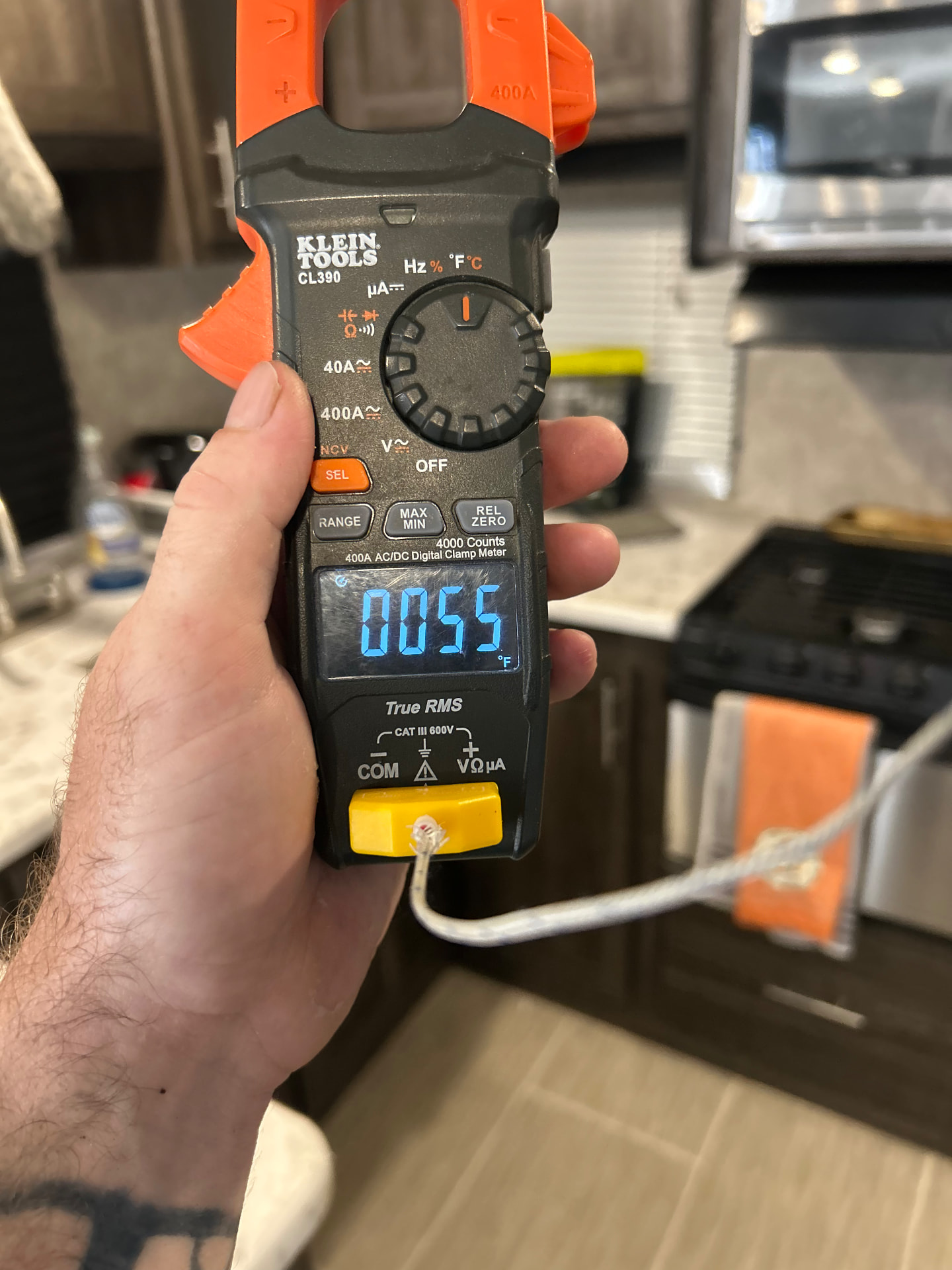 Technician checking an RV electrical system with a digital meter